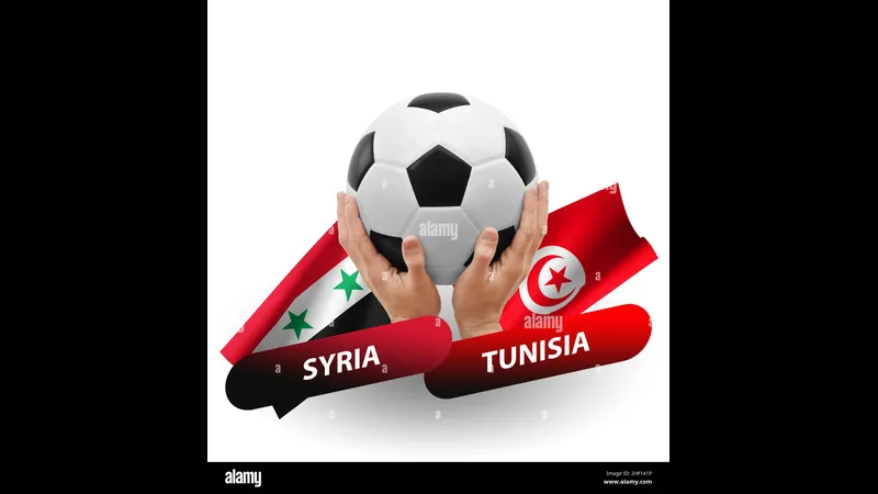 Cầu thủ Tunisia đi bóng qua cầu thủ Syria trong trận đấu sôi động